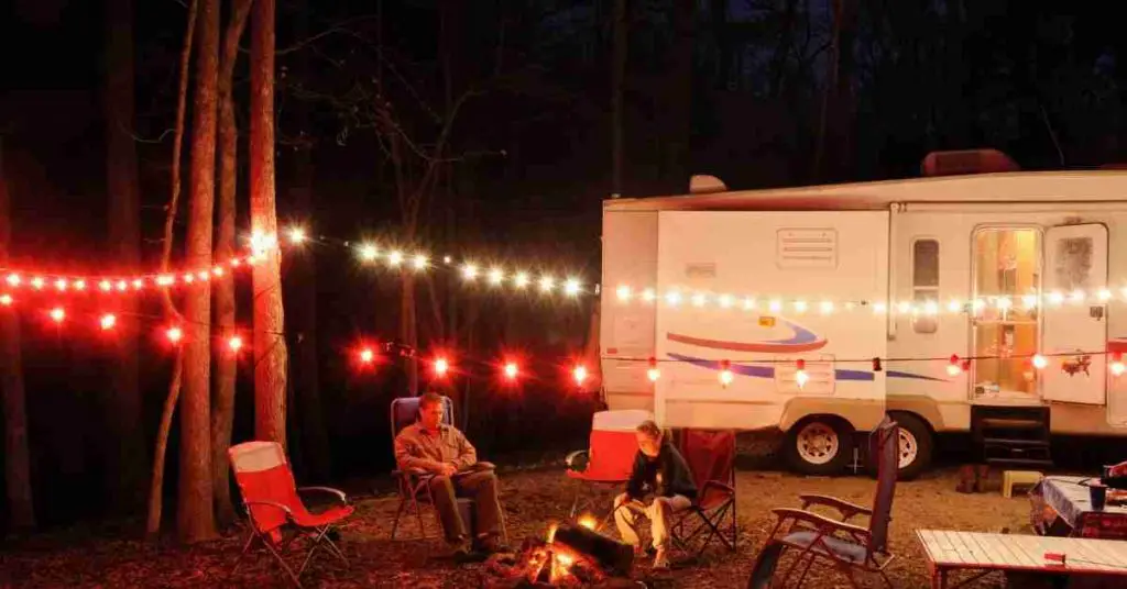 RV generators can be safely run overnight if you take proper precautions.  How long and how much fuel it uses varies widely based on if you intend to use a portable generator or a built-in generator.  Both built-in and portable generators are widely used and come with pros and cons that you should consider. In order to assist in keeping your generator running properly, you should perform routine maintenance and streamline how you use your generator.  Keeping your generator running beautifully can be as simple as changing your plugs and filters as needed, thereby lowering your overall fuel consumption.  Consider trading off with propane for things such as the refrigerator and water heater.  Also, consider adding solar panels to cut down on how much you need to use your generator. The two main types of generators for you to consider are built-in generators and portable generators.  Build-in generators are hardwired into your RV’s electrical system.  You start them with a button and they draw fuel from your RV’s fuel tank.  Meanwhile, portable generators will have to be stored in your RV, then moved outside in order to use them.  With build-in ones, you don’t have to lug it around and no one can steal it.  Portable ones are less expensive and are easier to access and maintain. Typically, built-in ones are noisier for you, but your neighbors will be happy because the outside noise is minimal.  Opposite of this, portable generators can be used a bit away from your RV, but your neighbors won’t appreciate the extra noise.  Both have pros and cons, so you should pick what best fits your lifestyle.  Further, you could have both and utilize either depending on what the situation calls for. How long can I leave my RV generator running? Portable generators can be run at different lengths of time depending on their model.  This range can be from 8 to 20 hours.  Since it takes about 2 gallons of fuel for a generator to run for 10 hours, you can calculate the amount of fuel you will need based on how long you wish to run it.  These generators hold 1 to 10 gallons of fuel at a time.  Further, portable generators can use either gas or propane. Built-in generators can run safely for several days, as long as they are properly maintained.  Their fuel reservoir differs from portable ones.  Propane generators are limited only by your propane tank capacity.  Gas-powered, built-in generators have tanks that vary widely from 6 to over 60 gallons.  Can you sleep with a generator on?  You will have plenty of time to get a good night’s sleep as generators will usually run for about 10 hours on two gallons of fuel.  Generators can be noisy, so take this into account if you are considering sleeping with your generator on.  Certain portable generators are as loud as a street with heavy traffic.  Consequently, some individuals find the consistent hum of a generator akin to a white noise machine. Another thing you should consider when possibly keeping your generator on at night is that portable generators are easy pickings for thieves.  After all, they are portable.  You can deter thieves by using a chain to attach it to something, such as a cable lock to your truck.  You could also pick up a cheap power failure light, which will alert you if your power from the generator goes out. If you are considering running a portable generator throughout the night, take the weather into account.  Pooling water increases the risk of electrocution.  Therefore, you should be mindful of rain and snow if you intend to use a portable generator.  Ensure you pick a place where it is less likely that water will collect and pool.  Also, look into a good generator tent.  Is it safe to sleep with a generator running in my RV?  Carbon monoxide poisoning is the main thing that you should be concerned about, especially if sleeping with a generator running.  Carbon monoxide has no odor, color, or taste; therefore, you need to be on alert.  Ensure that your carbon monoxide detector is working before using your generator. Symptoms that you should look out for are dizziness, throbbing temples, sleepiness, vomiting and nausea, intense headaches, muscular twitching, and the inability to think coherently.  If you are running your generator and experience these symptoms, you should immediately move outside for fresh air.  Then call 911 and seek medical assistance. In order to prevent possible carbon monoxide, there are several steps you can take.  You should close all doors, windows, and vents when using your generator.  If possible, retract your slides to ensure a better seal.  If you are using a portable generator, place it  15-20 feet away from your RV.  For an on-board generator, check its exhaust pipe for cracks or blockages before use. Do campgrounds allow RV generators at night?  Campground rules on RV generators being run at night varies from campground to campground.  Before running your generator all night, check with the campground you are at if it is okay or if it would violate any “quiet time” hours.  Older generators typically emit 80 decibels when running, while more modern ones are nearer 50 to 60 decibels.  To put that in perspective, 80 decibels sounds similar to a window air conditioner, a dishwasher, or a hairdryer.  Meanwhile, 50 to 60 decibels are similar in noise to the gentle hum of a refrigerator.  Newer, quieter models are significantly less likely to bother your neighbors at the RV park. Quiet hours in a campground are to ensure that individuals can get the uninterrupted sleep that they need.  Perhaps they need to leave early the next day for a long drive or they have work, either way, sleep is something that is important to many people at RV parks.  These hours are typically slotted from 10 pm and 6 am.  Be mindful of your neighbors in the campground and your next camping trip is sure to be enjoyable. Final Thoughts Yes, you can run your RV generator all night. Whilst it is possible to run your generator all night there are some precautions that you will need to follow.   Make sure that there is enough fuel to keep the generator powered all night. Keep the generator maintained so there is less chance of it malfunctioning whilst you are asleep. Follow the rules of the campsite, some don’t let you use RV generators all night because of the noise. Make sure that you have carbon monoxide alarms fitted in your RV. Try and buy the quietest generator that you can so you can sleep, and invest in some ear plugs if you are a light sleeper.  The above tips will help you run your RV generator all night.